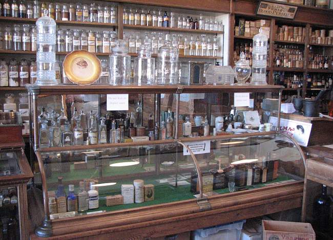 antique medicine bottles, jars and showcase