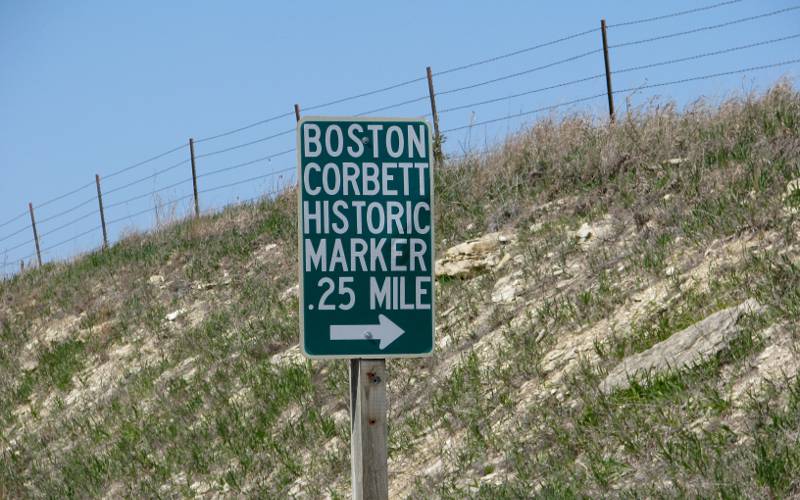 Direction sign to the Boston Corbett historic marker