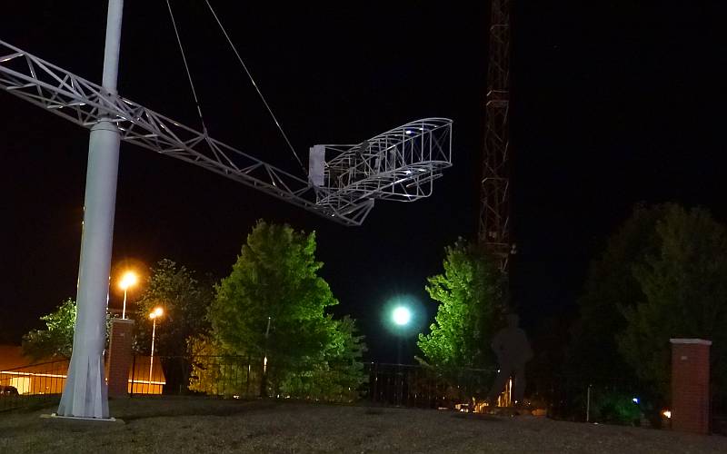 Wright Brothers plane sculpture at night