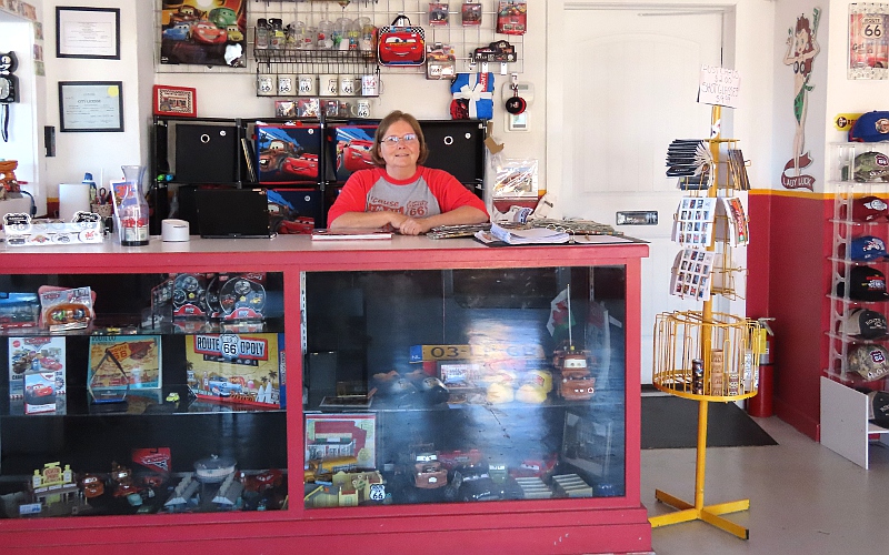Melba Rigg with scrap book and Radiator Springs memorabilia