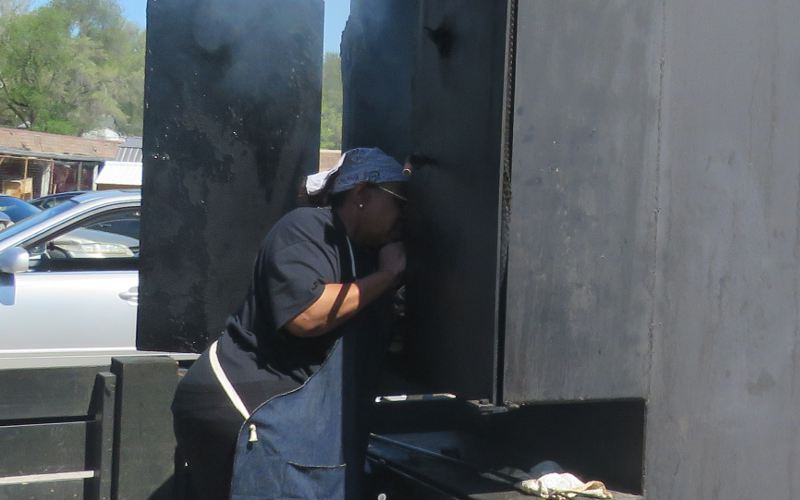 Deborah Jones checking meat in the smoker