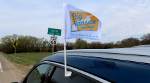 Bug Kansas Road Trip flag on car at Smith County Line