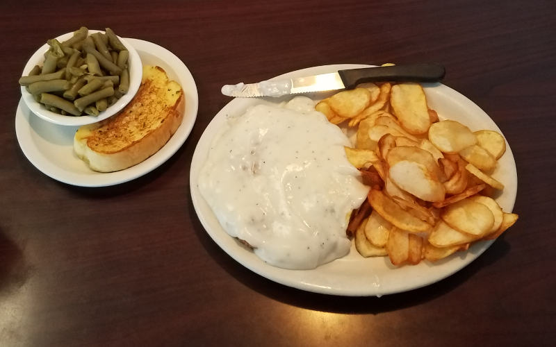 Chicken fried steak and fried potatoes