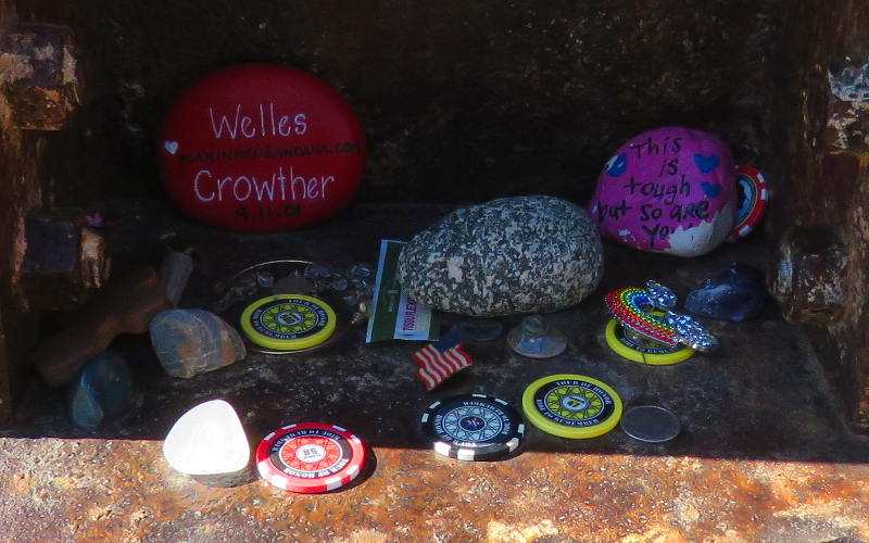 stones and coins left at the memorial